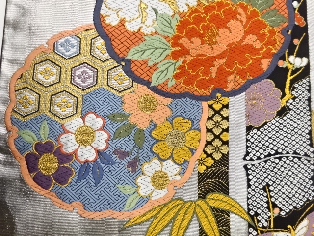  作家物　雪輪に花々・蝶・竹模様織出し袋帯